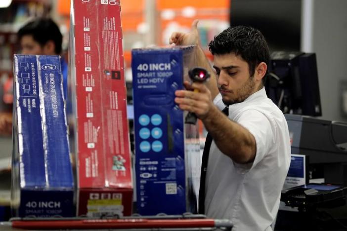 An employee scans television purchases during Black Friday sales at a Best Buy store in Los Angeles