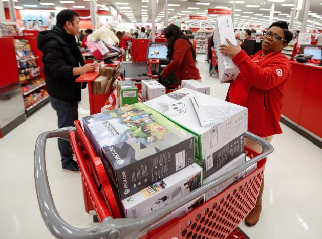 Store employee helps a customer with his purchase during the Black Friday sales event on Thanksgiving Day at Target in Chicago