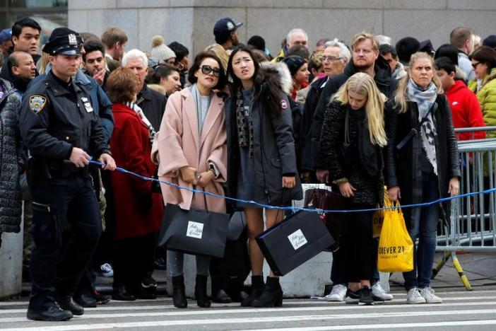 New York Police use tape to prohibit people crossing against the lights during Black Friday sales along Fifth Avenue store in Manhattan, New York, U.S.