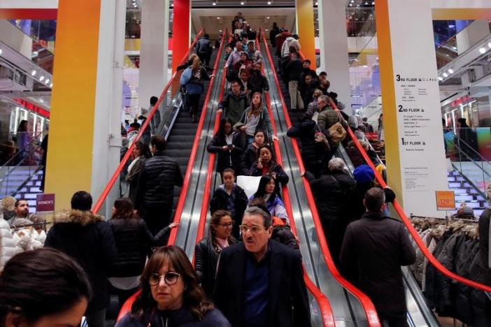 Shoppers ride escalators during Black Friday sales at the Uniqlo Fifth Avenue store in Manhattan, New York, U.S.