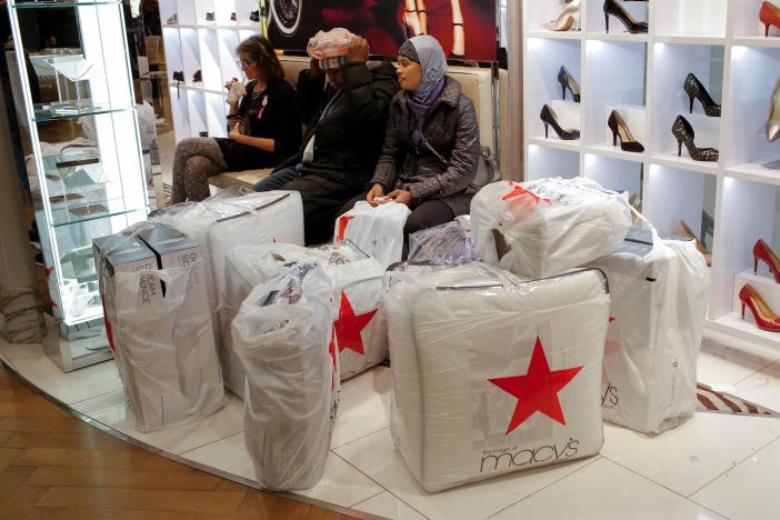 People wait with purchases at Macy\'s Herald Square during the Black Friday sales in Manhattan, New York, U.S.